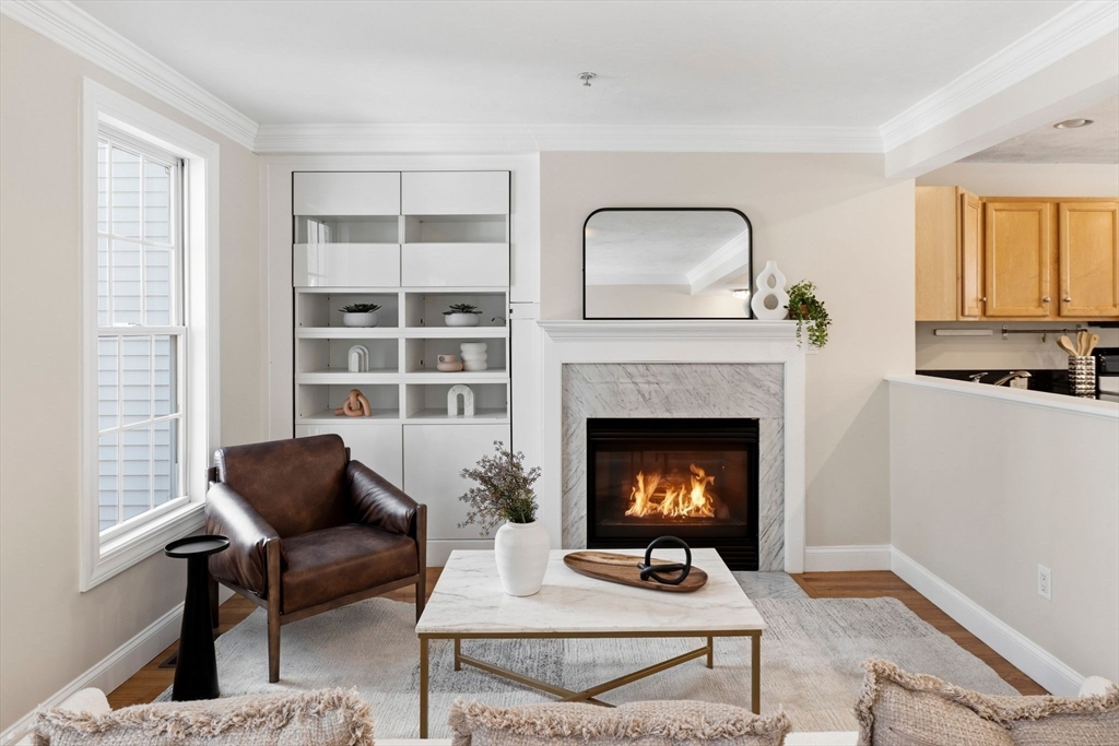 52 Packards Lane, Unit 4 Quincy, MA 02169 - Photo 5 of 40 a living room with furniture and a fireplace