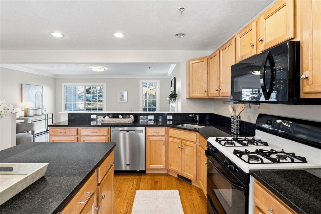 52 Packards Lane, Unit 4 Quincy, MA 02169 - Photo 7 of 40 a kitchen with a stove a sink and a refrigerator