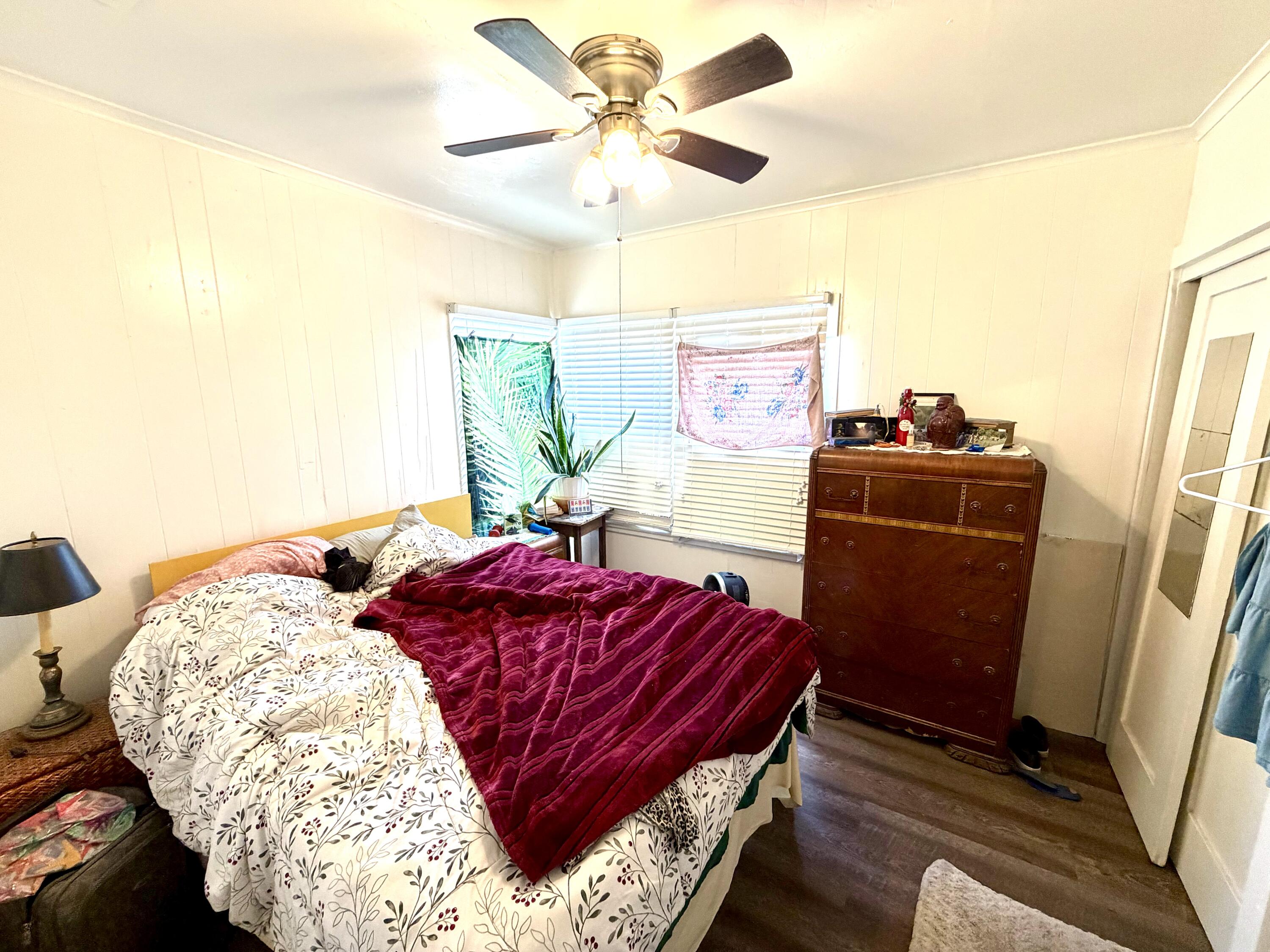 200 North B Street Exeter, CA 93221 - Photo 17 of 20 a living room with a bed and a dresser