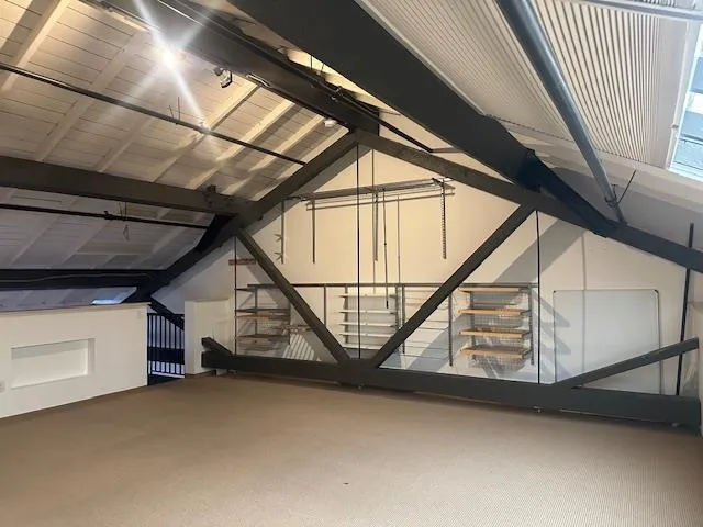 a view of an empty room with wooden stairs