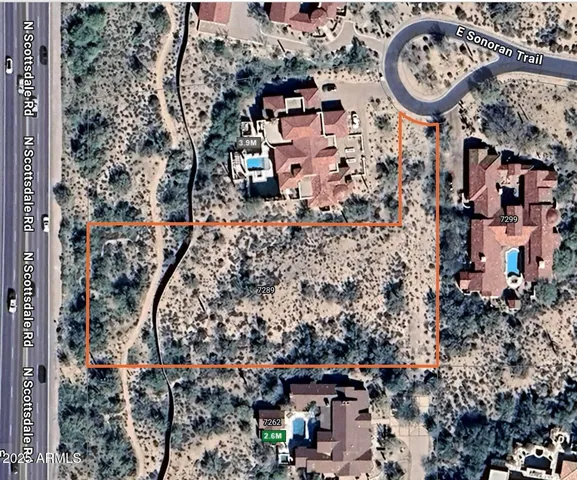 a view of a dirt road with a building in the background