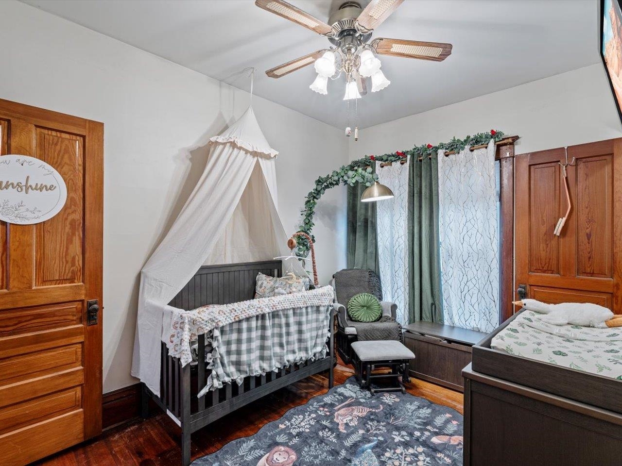 517 12th Street Dewitt, IA 52742 - Photo 28 of 40 a bedroom with a bed and a chandelier