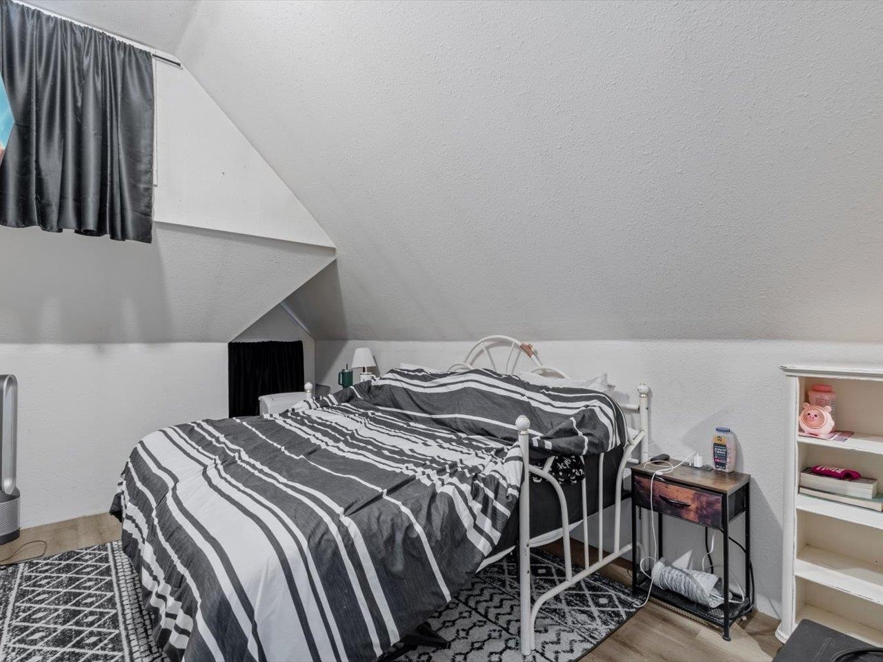 517 12th Street Dewitt, IA 52742 - Photo 34 of 40 a bedroom with a bed and a chandelier