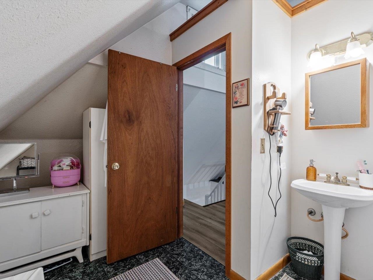 517 12th Street Dewitt, IA 52742 - Photo 38 of 40 a bathroom with a sink and a mirror