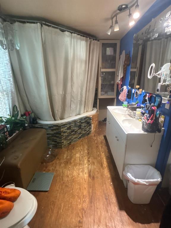 2102 North Grand Avenue Tyler, TX 75702 - Photo 11 of 13 Bathroom featuring vanity, wood-type flooring, and tiled shower / bath combo