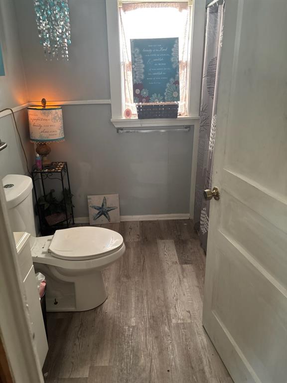 2102 North Grand Avenue Tyler, TX 75702 - Photo 8 of 13 Bathroom with a shower with shower curtain and light wood-style floors