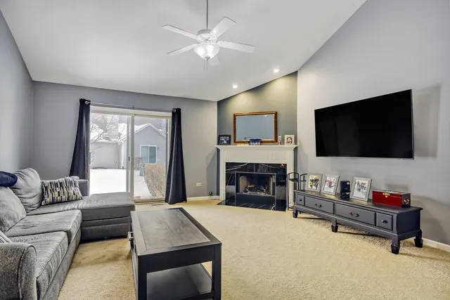 a living room with furniture fireplace and flat screen tv