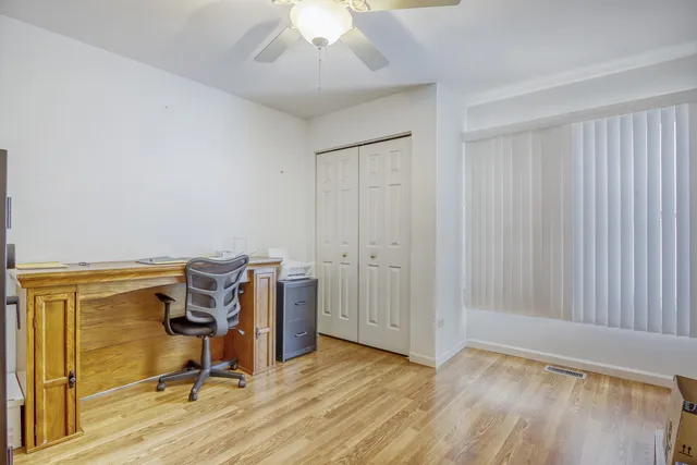 a view of a workspace with furniture and a window