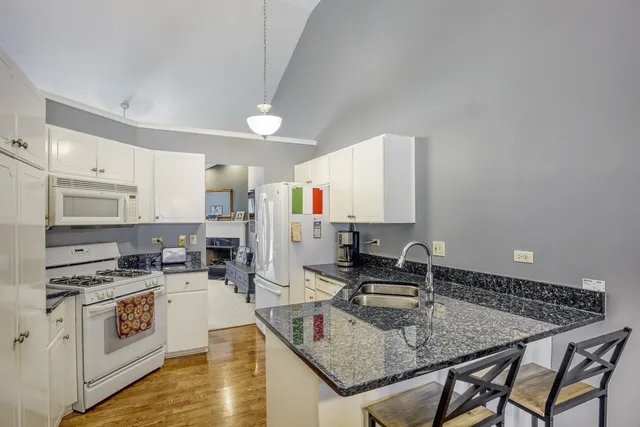a kitchen with a stove a sink and a refrigerator