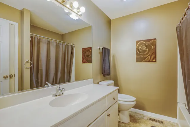 a bathroom with a sink a toilet and mirror