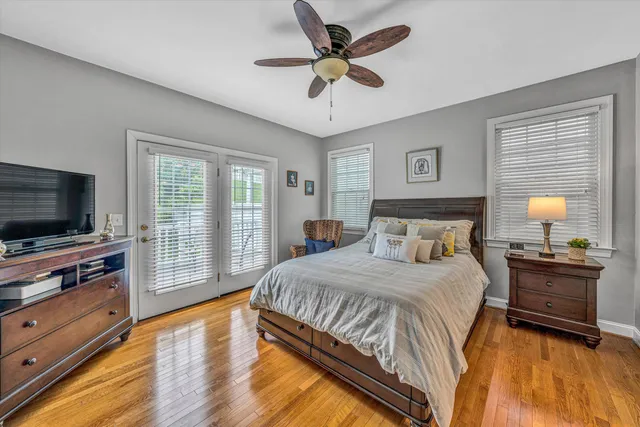 a bedroom with a large bed and a flat screen tv