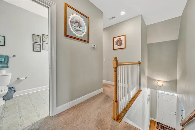 a view of a hallway with paintings on the wall