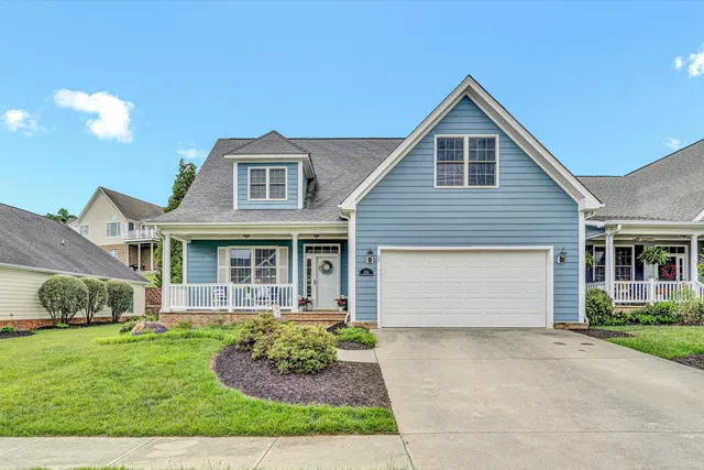 a front view of a house with a garden and plants