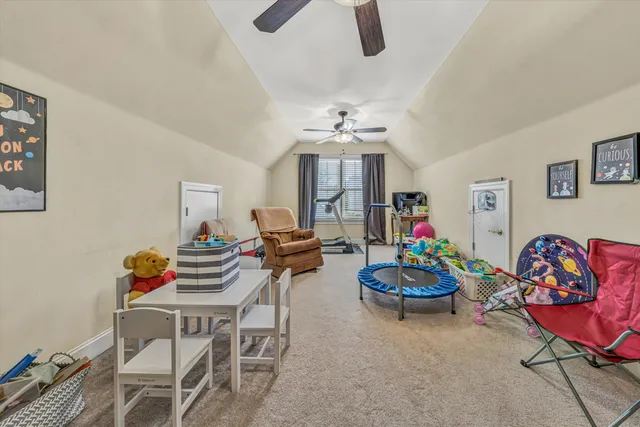 a bedroom with a bed a chandelier and a window