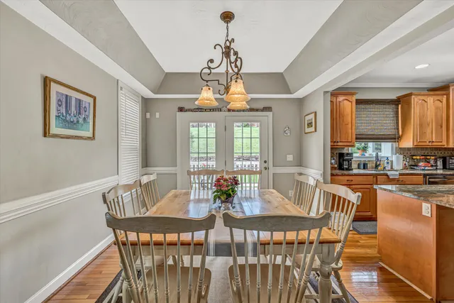 a dining room with furniture a chandelier and window