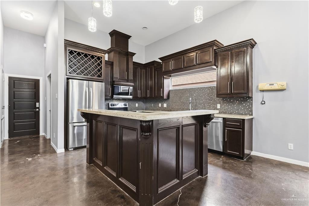 1342 Patsy Cline Drive Edinburg, TX 78541 - Photo 2 of 18 a kitchen with stainless steel appliances granite countertop a stove and a refrigerator