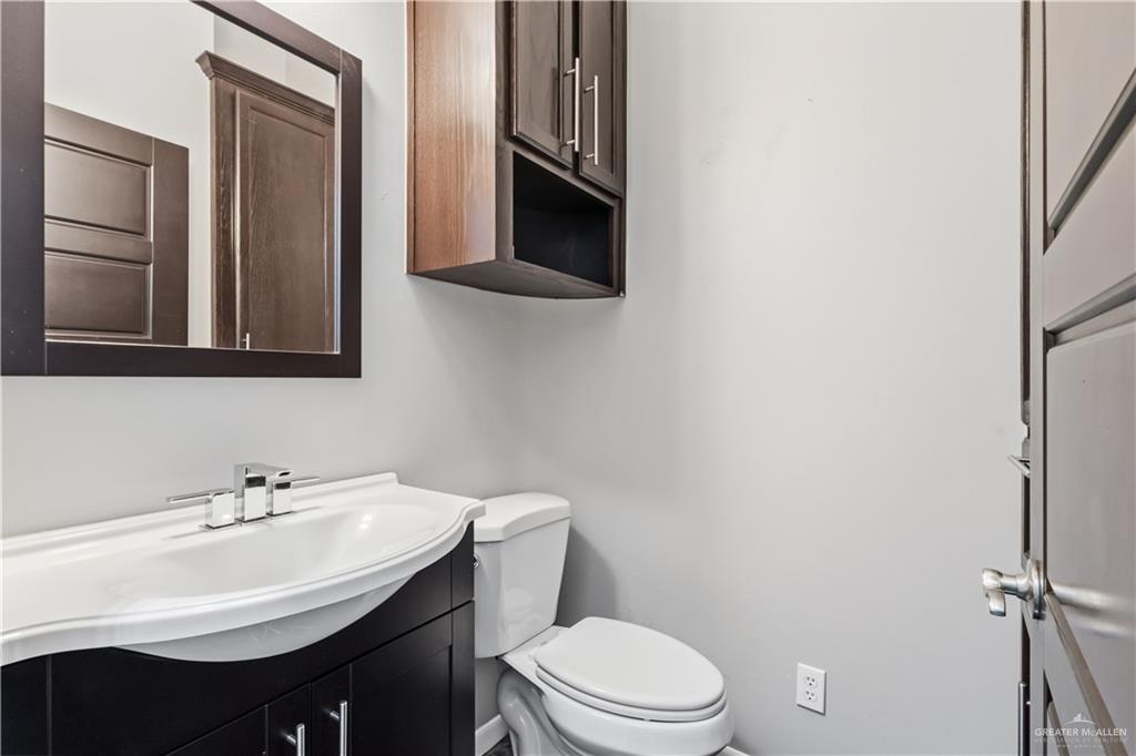 1342 Patsy Cline Drive Edinburg, TX 78541 - Photo 7 of 18 a bathroom with a sink a toilet and mirror