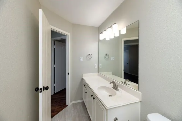 a bathroom with a double vanity sink and a mirror