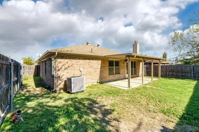 a view of a house with backyard and sitting area