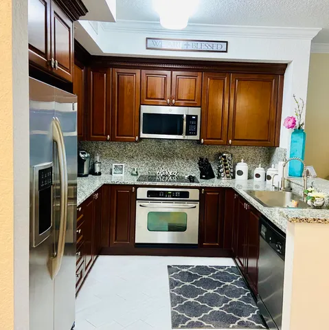 a kitchen with a sink a refrigerator and a stove