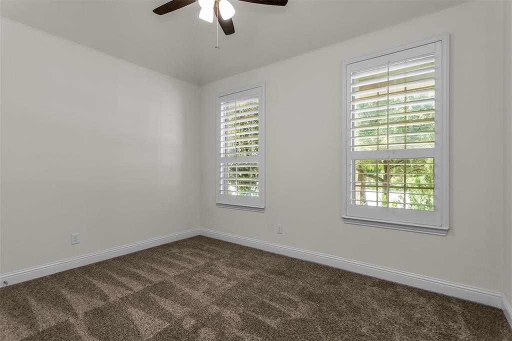 15713 Canyon Ridge Prosper, TX 75078 - Photo 7 of 38 Bedroom with white plantation shutters, and a ceiling fan with integrated lighting
