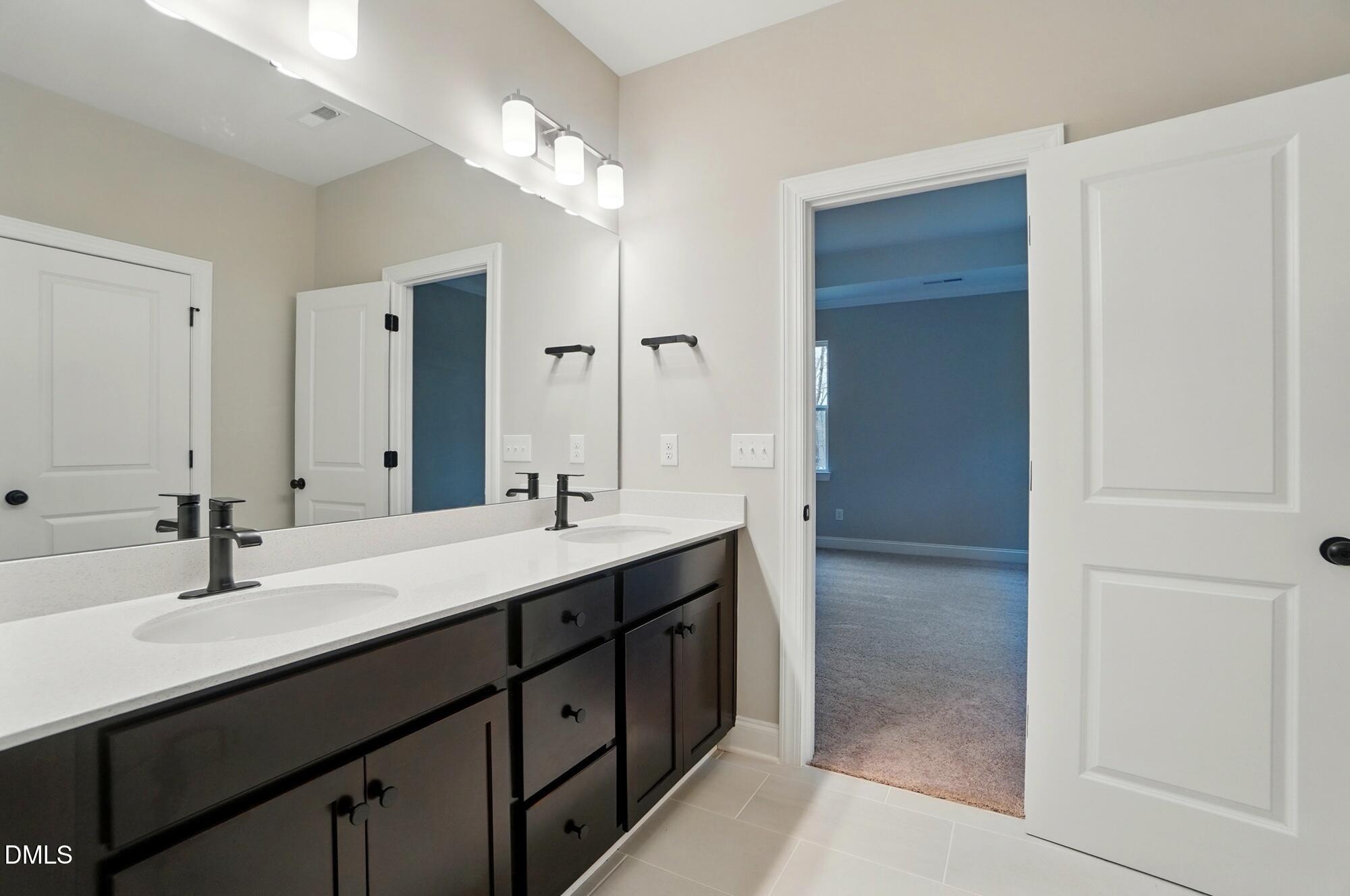 285 Gilliland Road Siler City, NC 27344 - Photo 19 of 45 a bathroom with a double vanity sink mirror and next to a window