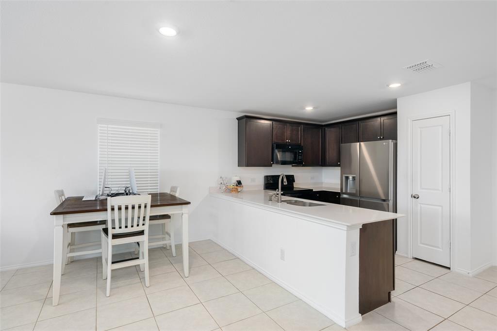 5848 Timber Pt Drive Princeton, TX 75407 - Photo 11 of 15 a kitchen that has a cabinets counter space and appliances