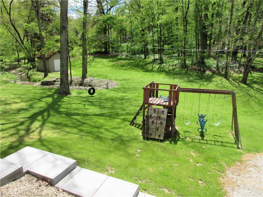 244 Harbison Road Sarver, PA 16055 - Photo 22 of 25 New concrete steps and sidewalk leading from back deck to back yard. Great children's wooden play set with swings, rock wall, and slide.