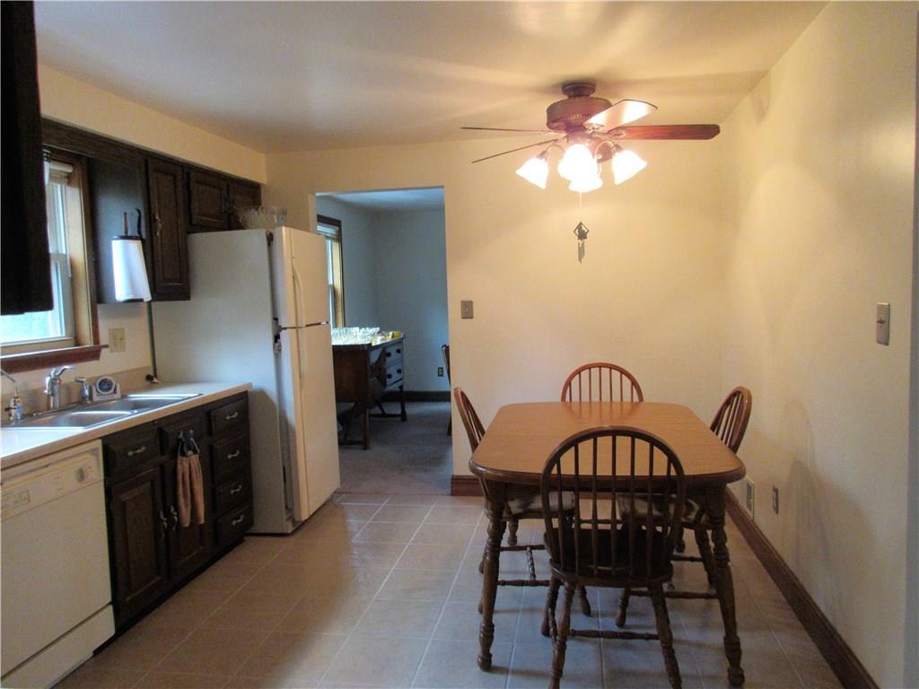 244 Harbison Road Sarver, PA 16055 - Photo 8 of 25 Dining room connects to eat-in kitchen. Kitchen has a ceiling fan with light.