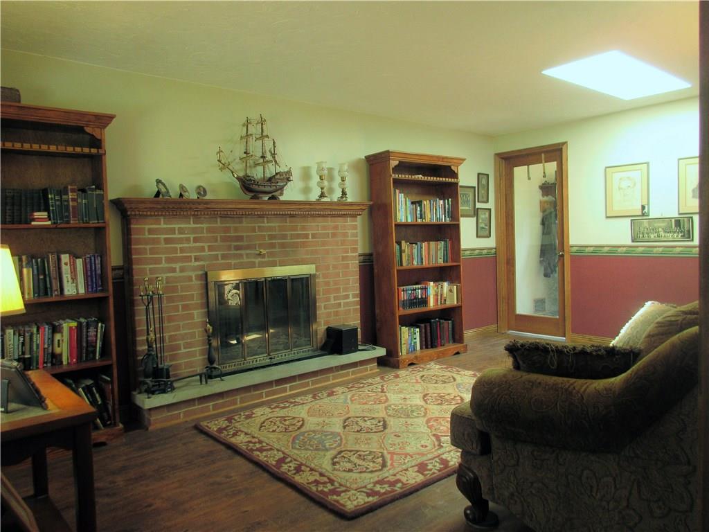 244 Harbison Road Sarver, PA 16055 - Photo 10 of 25 Family room with great, brick wood-burning fireplace and large mantle for decor. Family room is connected to entry, kitchen, half bath, and laundry.
