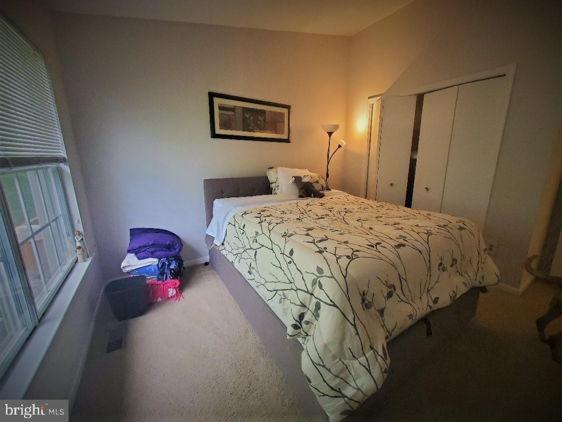 1479 Casino Circle Silver Spring, MD 20906 - Photo 14 of 24 a bedroom with a bed and a chandelier