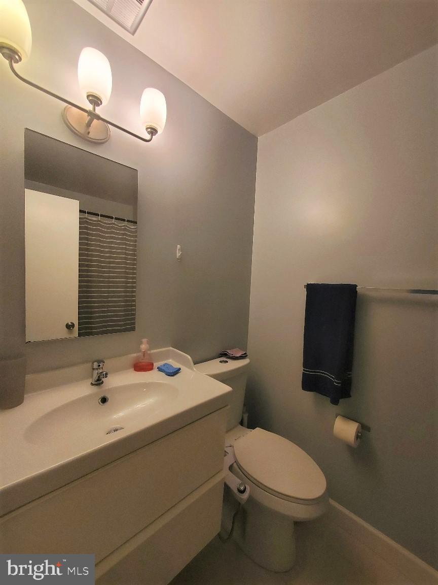 1479 Casino Circle Silver Spring, MD 20906 - Photo 20 of 24 a bathroom with a sink a toilet and mirror