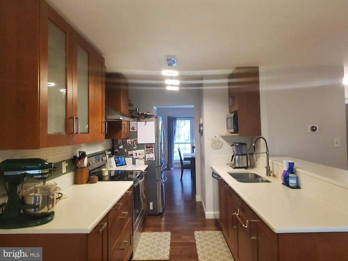 1479 Casino Circle Silver Spring, MD 20906 - Photo 3 of 24 a kitchen with a sink a stove and chairs