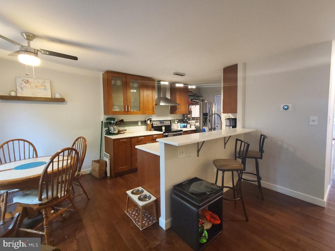 1479 Casino Circle Silver Spring, MD 20906 - Photo 7 of 24 a kitchen with a dining table chairs and a refrigerator