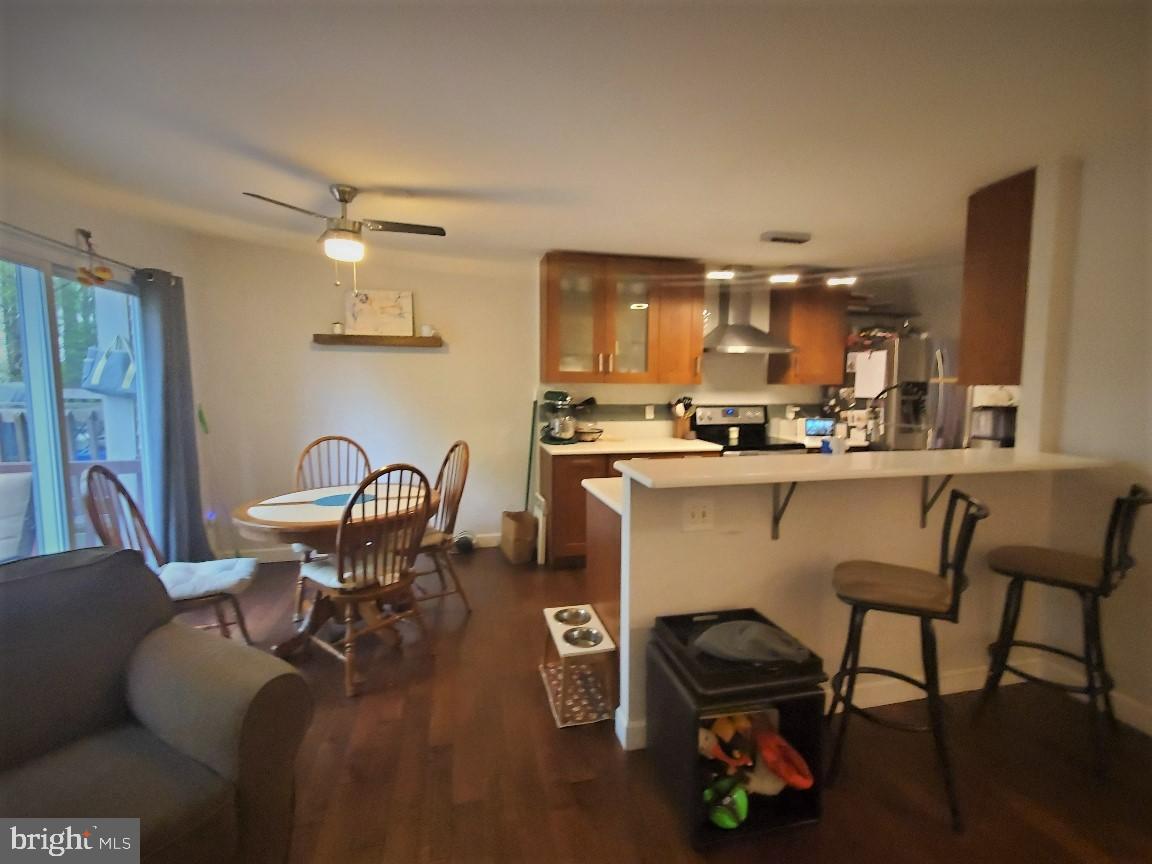 1479 Casino Circle Silver Spring, MD 20906 - Photo 8 of 24 a kitchen with a dining table chairs and stove