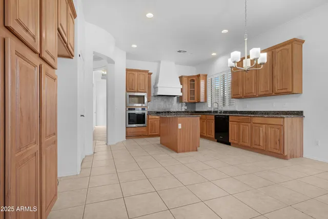 a view of empty room with wooden floor and window