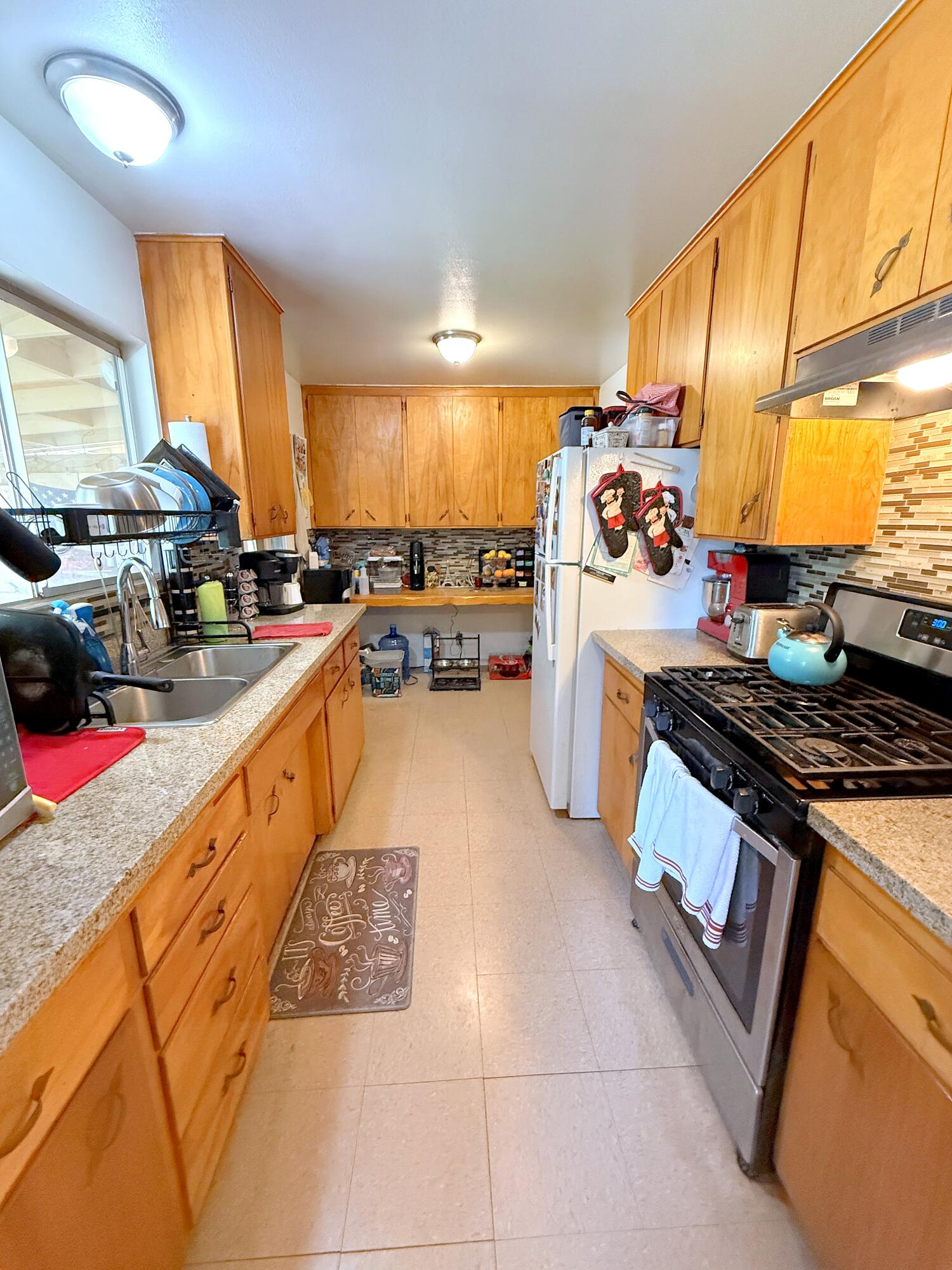 50 East Portal Street Oak View, CA 93022 - Photo 24 of 33 a kitchen with stainless steel appliances granite countertop a stove a sink and a refrigerator