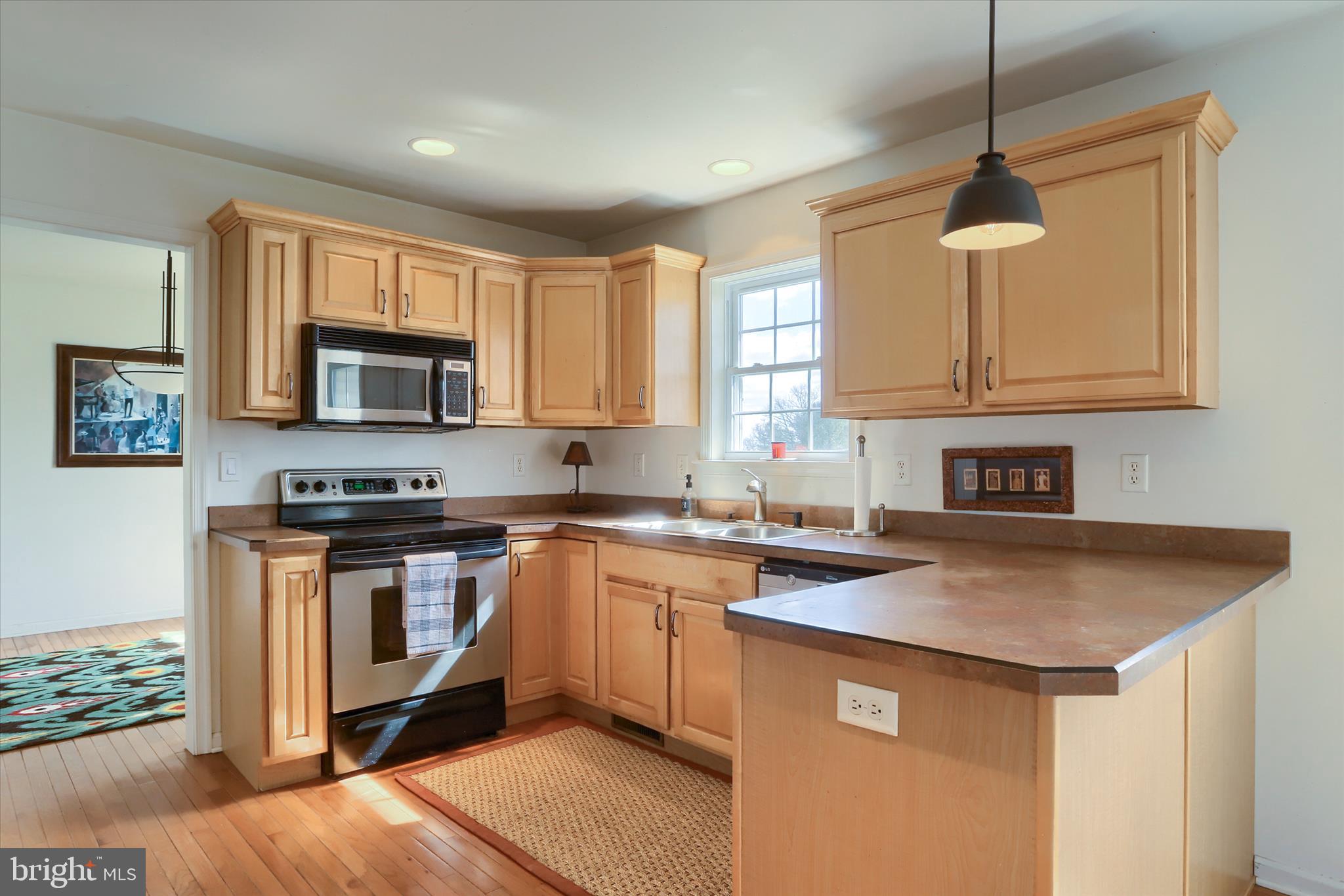 440 Whisler Road Etters, PA 17319 - Photo 6 of 33 a kitchen with stainless steel appliances granite countertop a sink stove and microwave