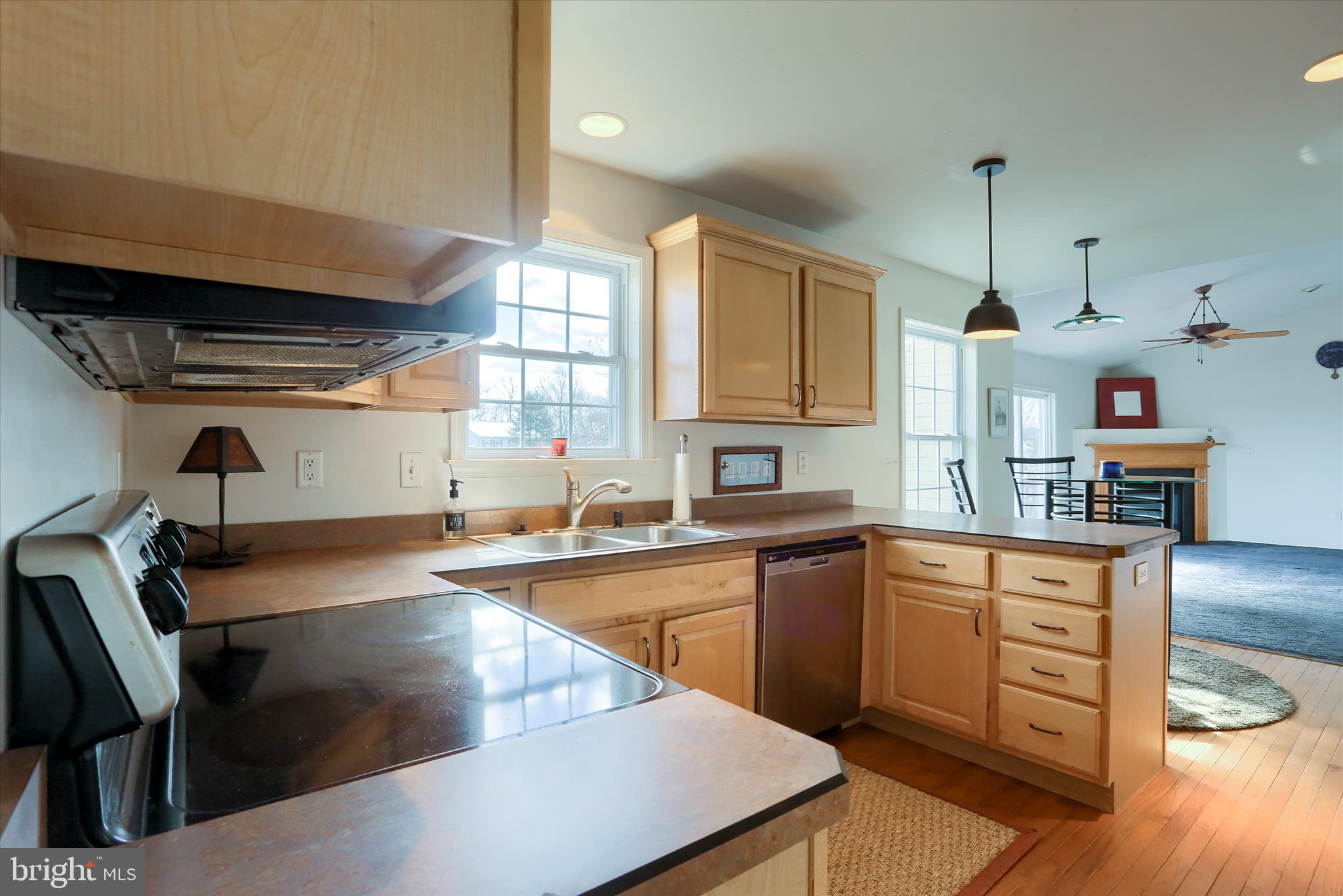 440 Whisler Road Etters, PA 17319 - Photo 7 of 33 a kitchen with wooden cabinets a sink a stove and wooden floor