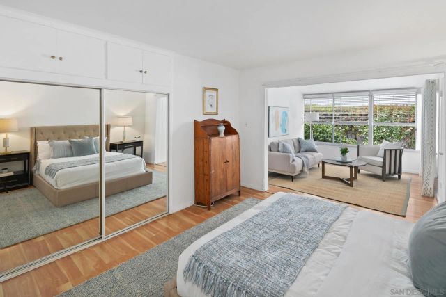 a bedroom with a bed and large window