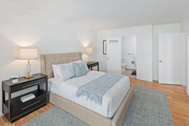 a bedroom with a bed and a lamp on table