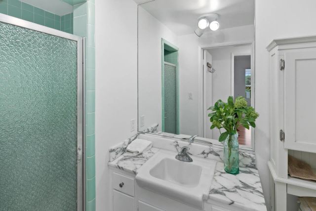 a bathroom with a sink a vanity and a mirror