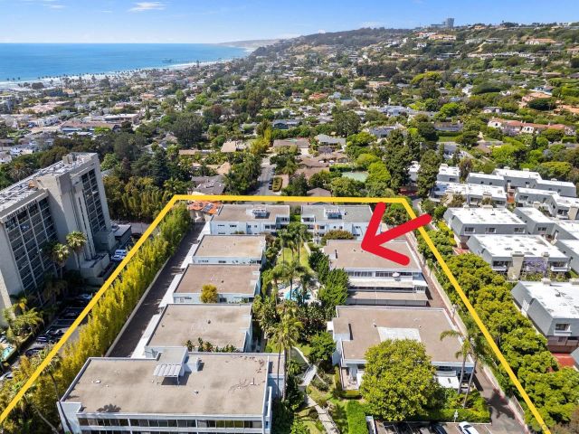 an aerial view of residential houses with outdoor space