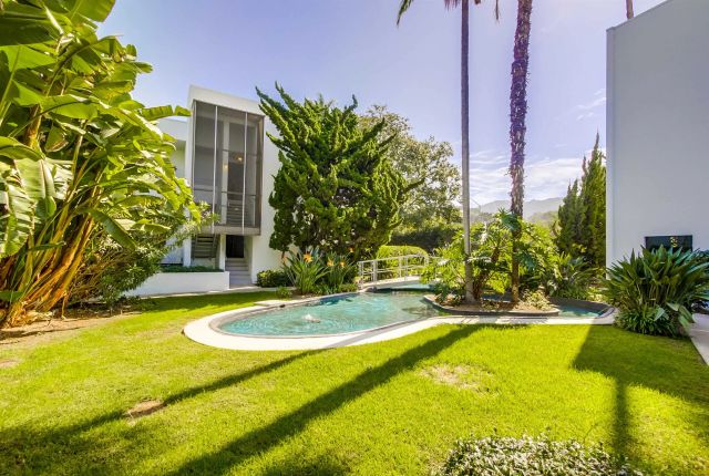 a view of a swimming pool with a yard