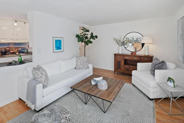 a living room with furniture and a clock