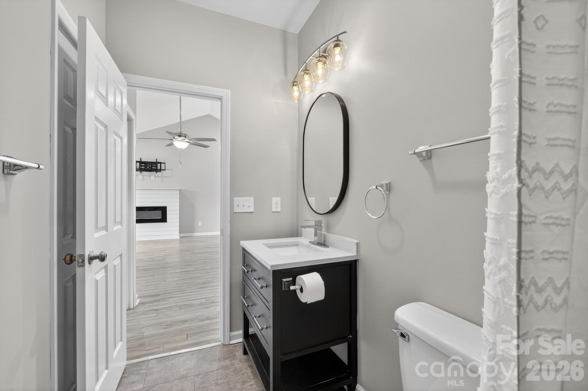 2119 South Road Morganton, NC 28655 - Photo 32 of 47 a bathroom with a sink a toilet a mirror and shower