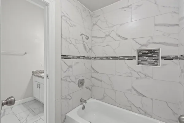 a bathroom with a bathtub and shower
