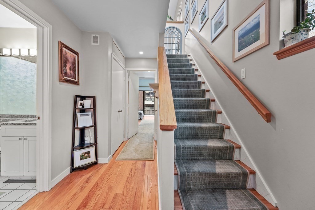 6 Shipway Place, Unit 6 Boston, MA 02129 - Photo 11 of 25 a view of staircase with lots of frames on wall and wooden floor
