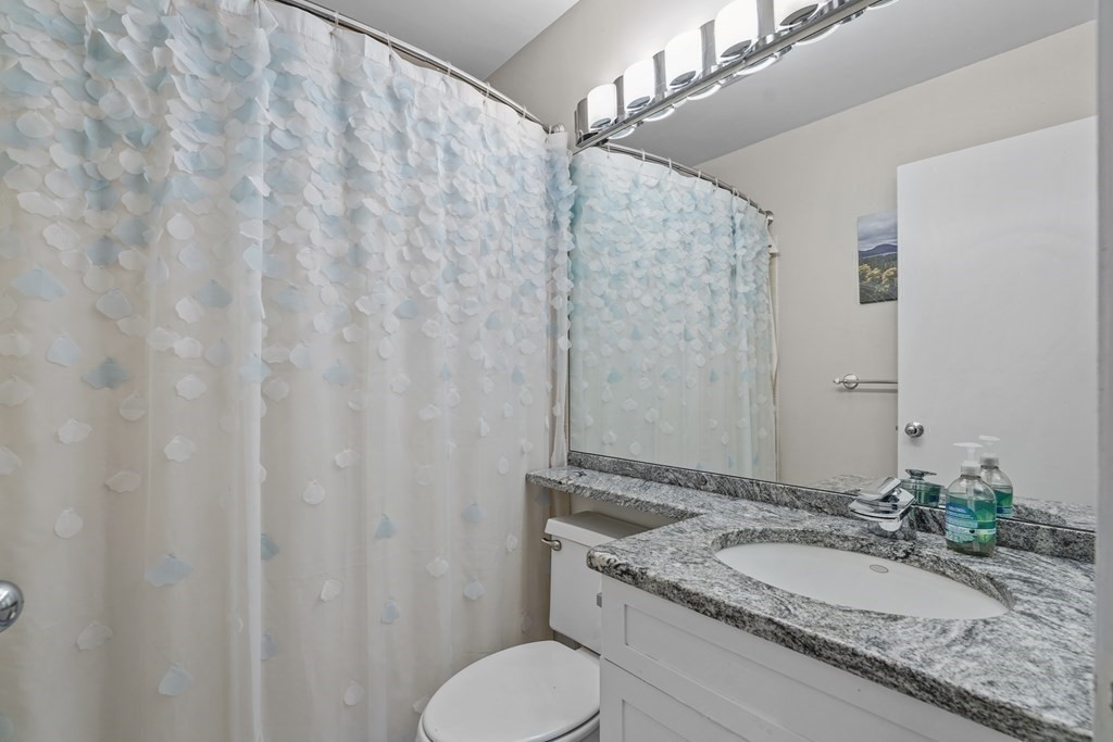6 Shipway Place, Unit 6 Boston, MA 02129 - Photo 16 of 25 a bathroom with a granite countertop sink and a mirror