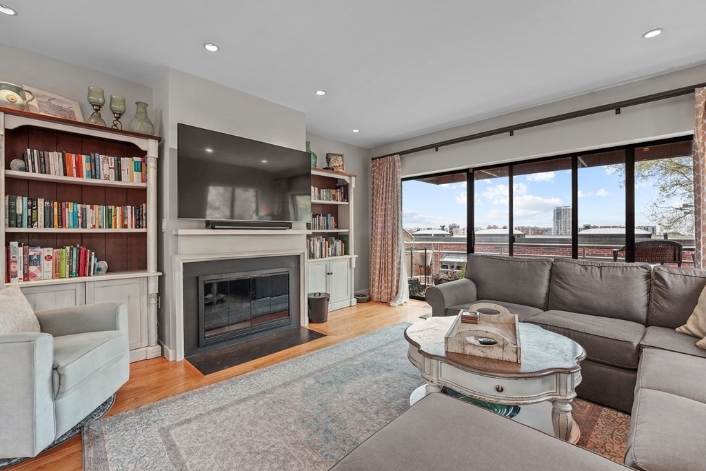 6 Shipway Place, Unit 6 Boston, MA 02129 - Photo 4 of 25 a living room with furniture a flat screen tv and a fireplace